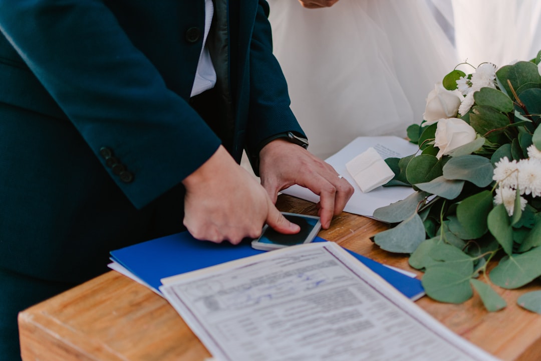 Newly married couple signing their marriage certificate
